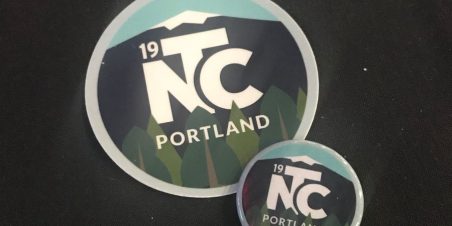 photo of conference branded sticker and button