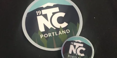 photo of conference branded sticker and button