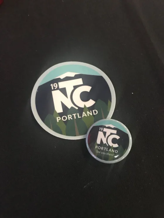 photo of conference branded sticker and button