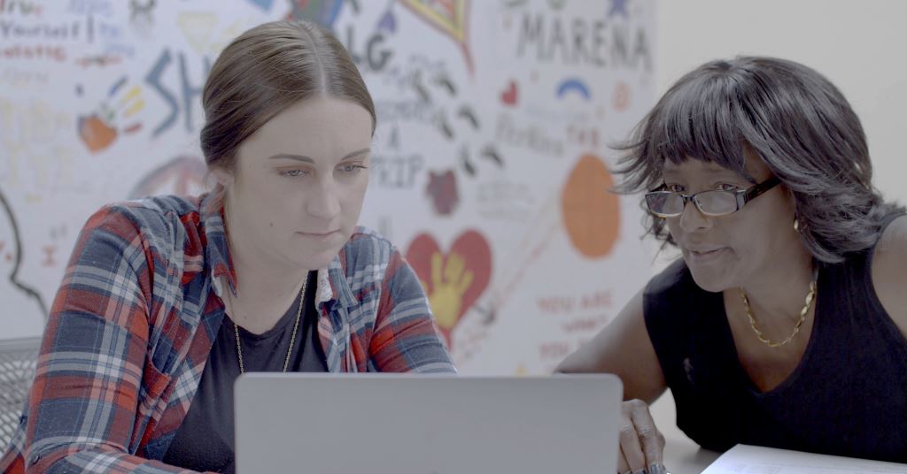 Photo: Staff CHD staff members looking at a laptop screen.