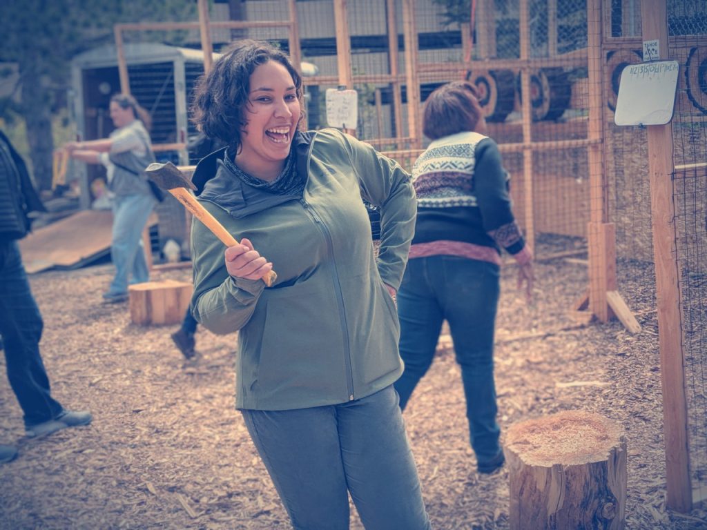 Photo: Eshe has a laugh learning to throw an ax