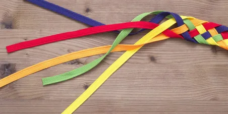 Photo: Multiple strands of different colored fabric interwoven into one larger braid.