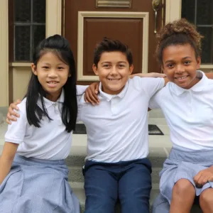 Photo: School children sitting on steps smiling