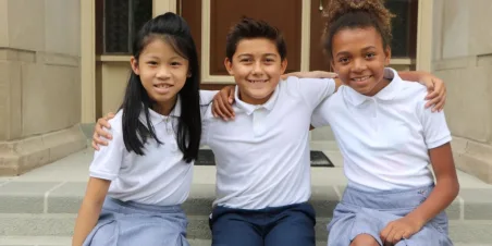 Photo: School children sitting on steps smiling