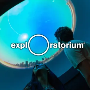 Image: Exploratorium logo with image of visitors looking at an exhibit