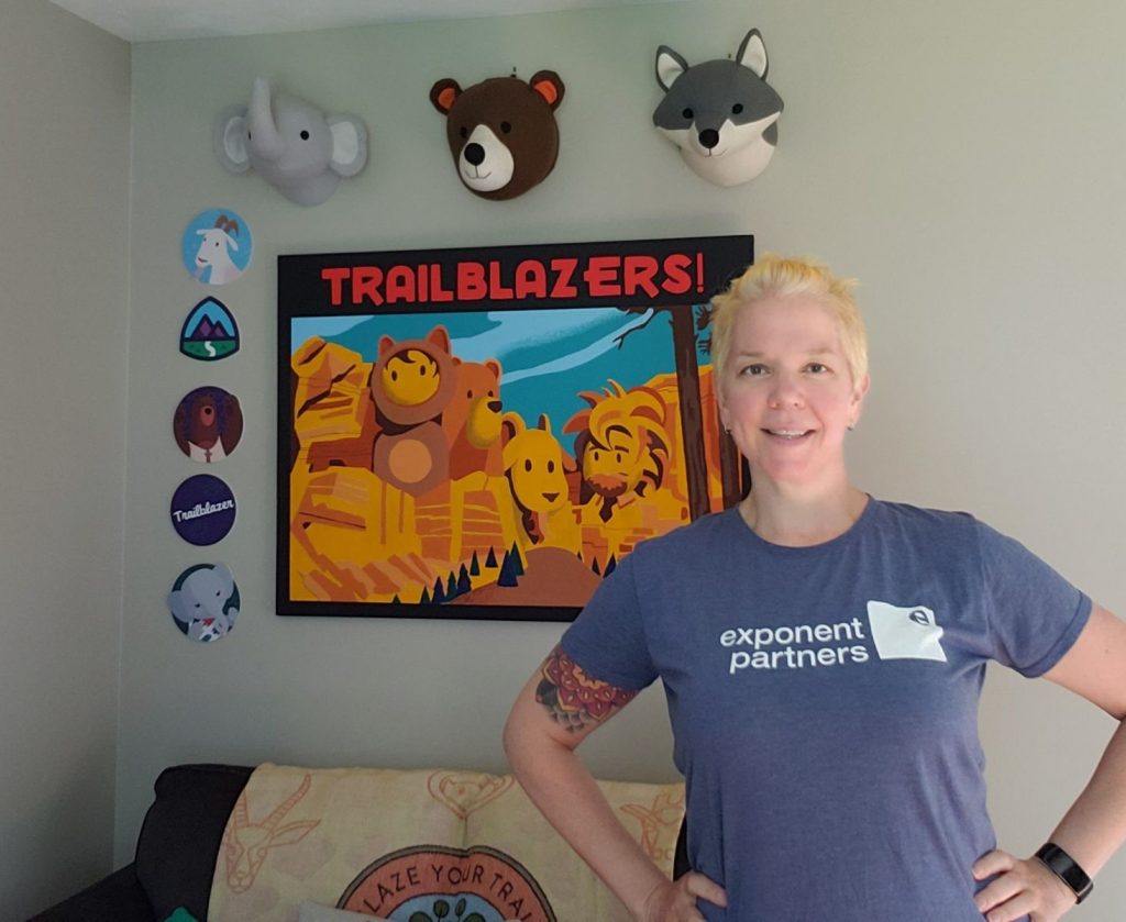 Photo of Skye wearing her Exponent Partners t-shirt surrounded by Salesforce swag