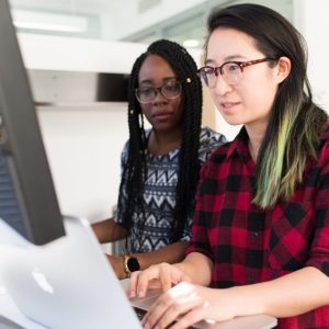 Photo of two women working together at a computer