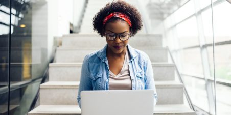Young professional Black woman working on a laptop