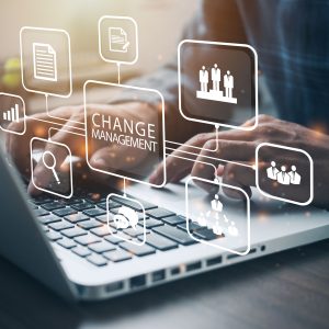 Hands on laptop with change management concept graphics