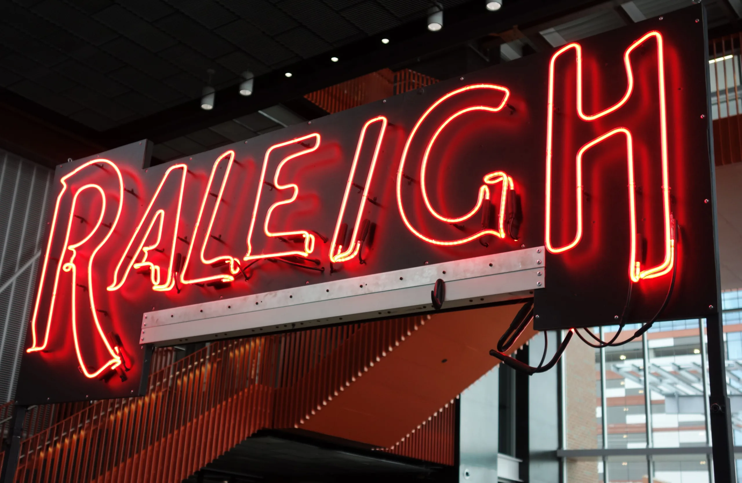 Picture of lit neon sign that says Raleigh